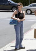 Ashley Benson wears a black cropped tank to and jeans while out shopping with a friend in Los Angeles