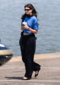 Kaia Gerber wears a blue crop top and black trousers while seen heading to a helipad in New York City