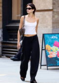 Kaia Gerber displays her svelte frame in a white camisole top and black sweatpants while she grabs a vegan salad bowl in SoHo, New York City