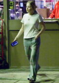 Ellie Bamber dressed casual in a white tee and floral print jeans while seen at a petrol station in Central London, England
