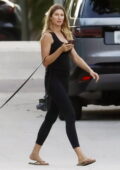 Gisele Bundchen wears black tank top and leggings while walking her dogs in Miami Beach, Florida