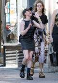 Maisie Williams shows off singing skills while out on a stroll with friends in London, England