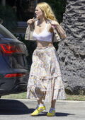 Rumer Willis wears a cropped white tank top and floral print skirt as she leaves a birthday party in Long Beach, California