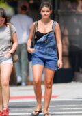 Suri Cruise wears a black tank top and denim shortalls while out with a friend in New York City