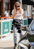Ashley Benson rocks a white t-shirt and blue jeans during a family lunch outing at Cipriani in Beverly Hills, California
