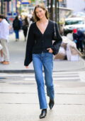 Karlie Kloss looks casual chic in a navy cardigan and jeans while out for a stroll in New York City