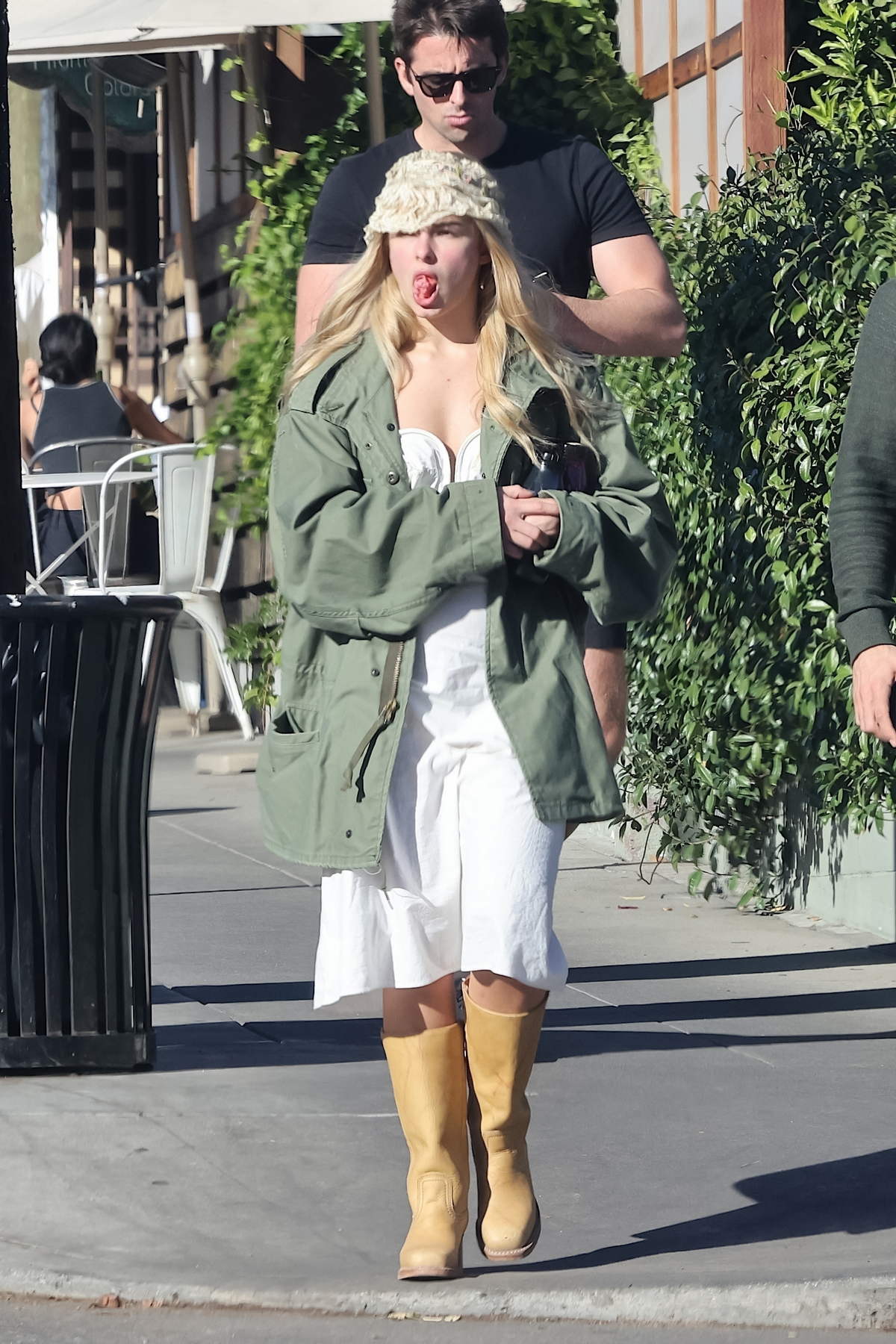 Addison Rae is casually chic in a white dress and green jacket while out to lunch with friends in Los Feliz, California