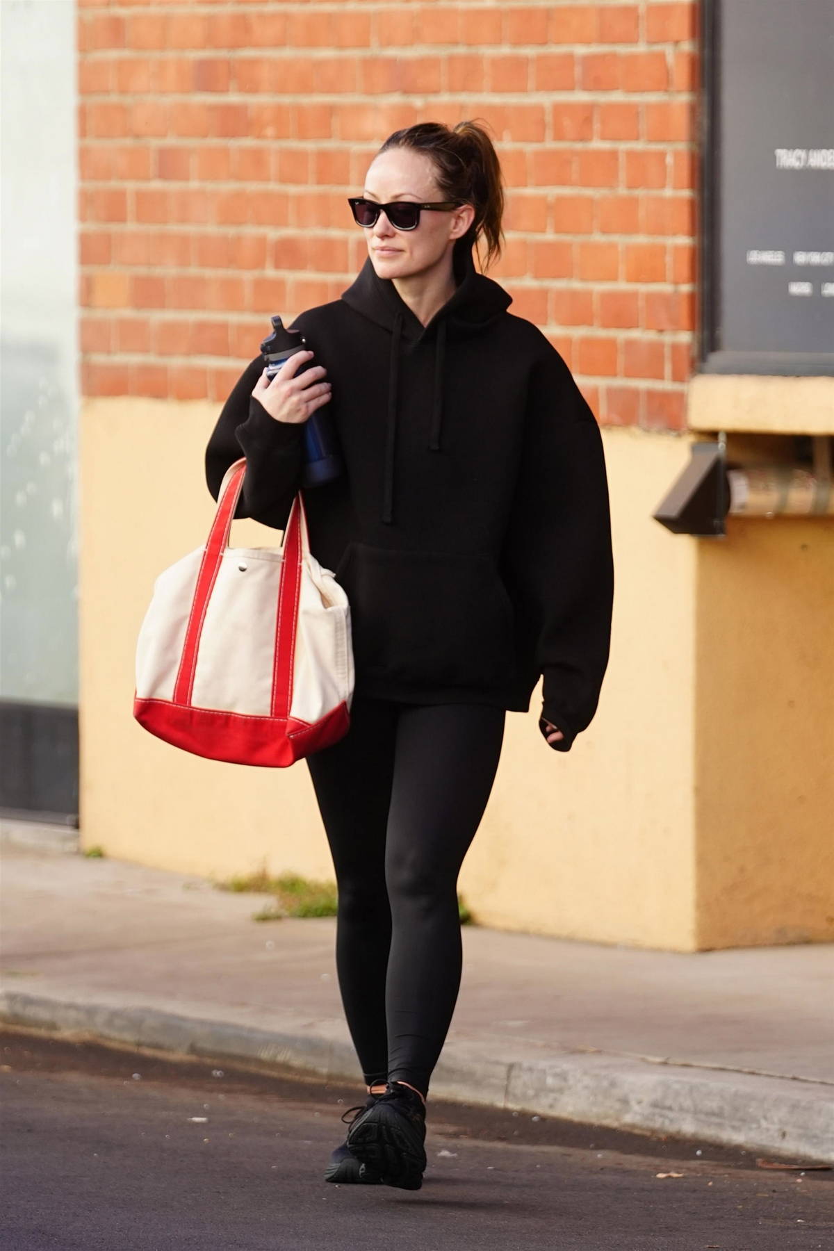 Olivia Wilde sports a black hoodie and leggings while seen leaving after a workout in Studio City, California